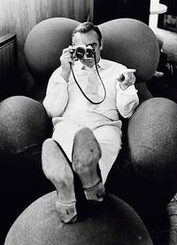 Sean Connery peers through a camera on the set of the James Bond film 